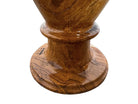 An elegant, hand-carved decorative vase made of polished Pakistani brown onyx. The vase features a classic, rounded urn shape with a tiered, flared neck and a solid matching spherical stone stopper resting on top. The stone displays rich, natural horizontal banding and swirling patterns in shades of honey, deep amber, rust-red, and cream. It stands on a small, integrated pedestal base against a clean white background, reflecting a high-gloss, mirror-like finish.
