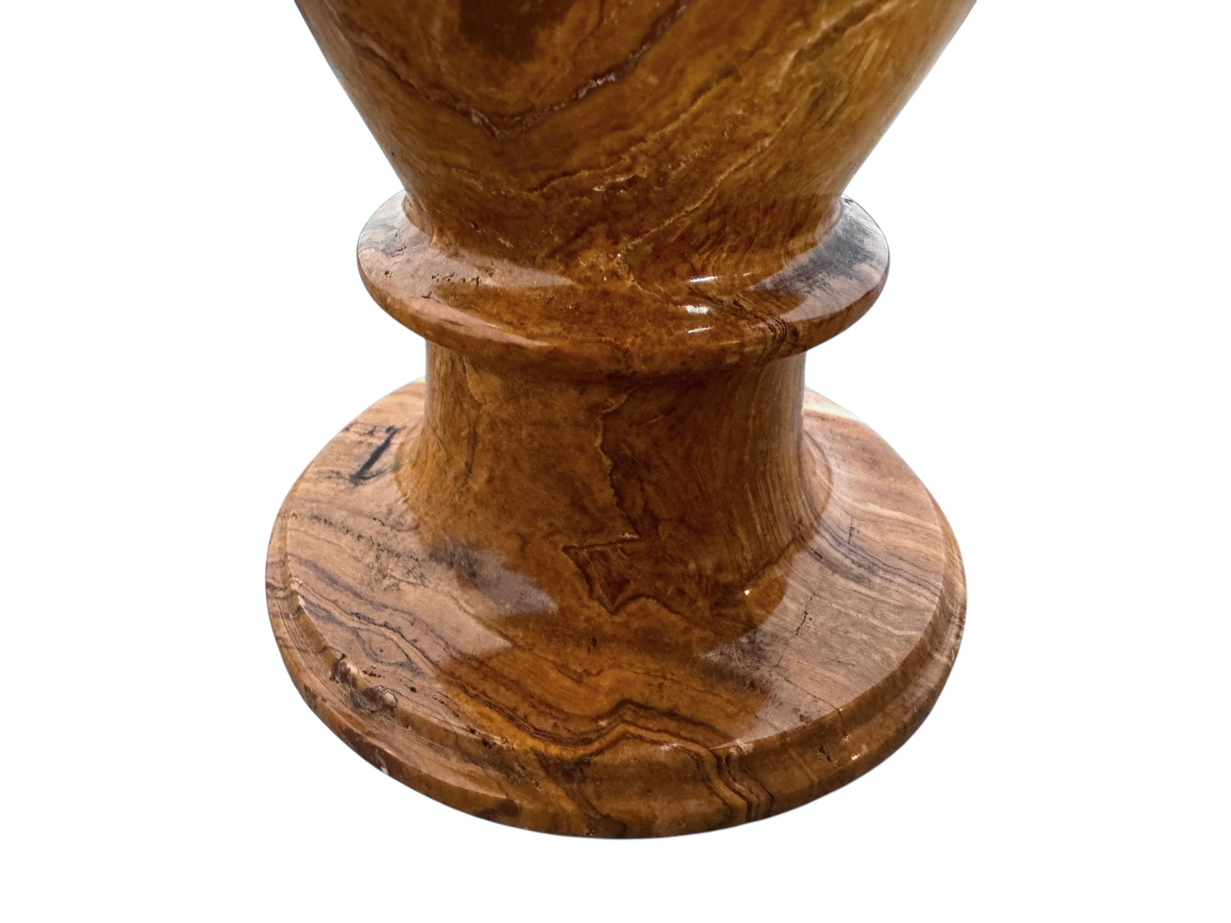 An elegant, hand-carved decorative vase made of polished Pakistani brown onyx. The vase features a classic, rounded urn shape with a tiered, flared neck and a solid matching spherical stone stopper resting on top. The stone displays rich, natural horizontal banding and swirling patterns in shades of honey, deep amber, rust-red, and cream. It stands on a small, integrated pedestal base against a clean white background, reflecting a high-gloss, mirror-like finish.
