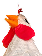 A white chicken pinata with red comb and wattles, and orange beak and legs, standing upright.