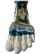 Close-up of Domenico Pinto's 'Mare Dentro' ceramic sculpture: foot, ship with gold sail, Apulian style