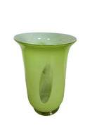 A mid-century modern, lime green cased-glass vase with a wide, flared rim and a thick, clear glass base. The exterior is a glossy chartreuse green, while the interior is lined with solid milk-white glass. The defining feature is a large, vertical oval cutout window that pierces directly through the center of the vase's body, creating an open-air negative space.