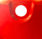 A top-down, straight-on view of a vintage, high-gloss cherry red bathtub. The tub basin is molded into a distinct double-tiered heart shape, with a shallower outer heart cascading into a deeper, smaller inner heart basin centered within a wide rectangular red deck.