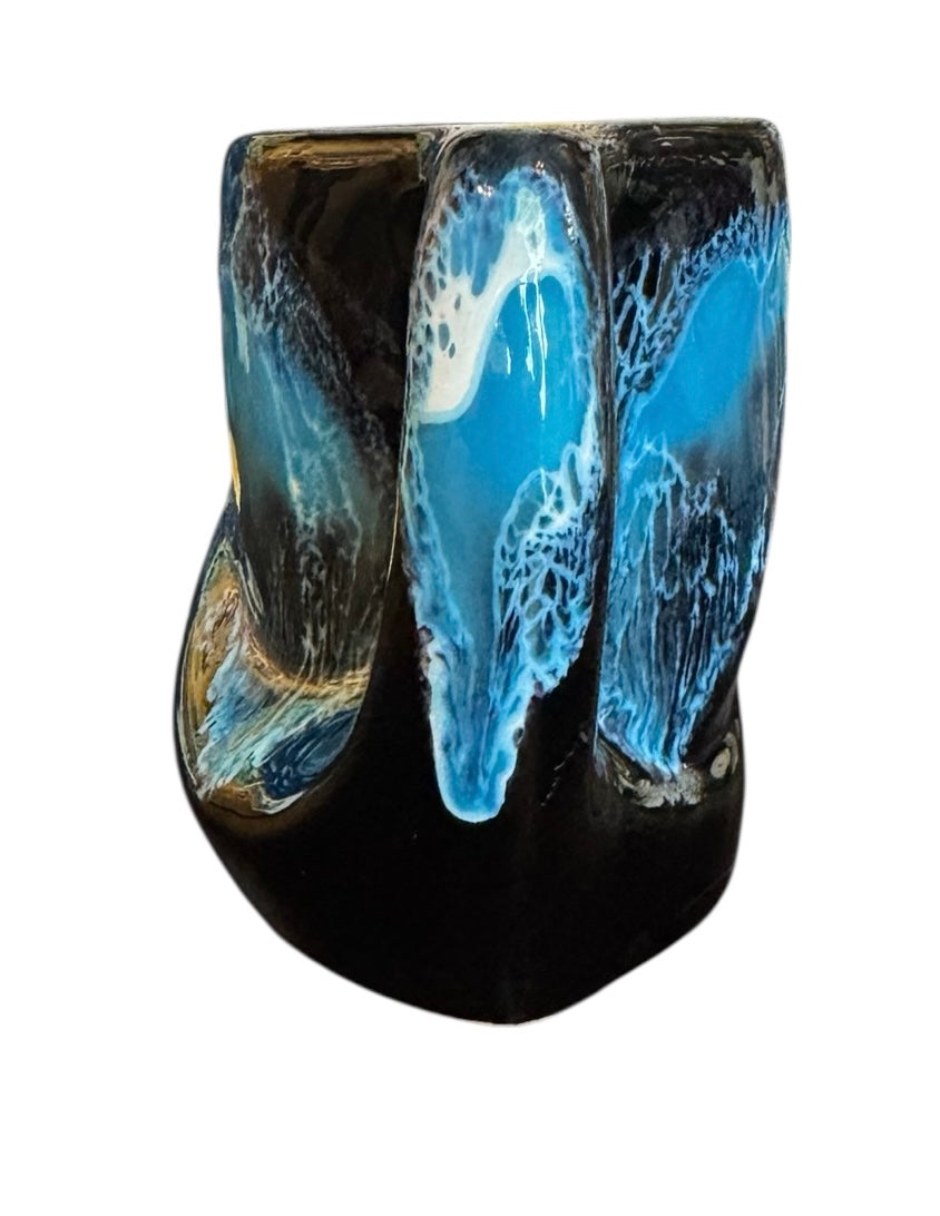 Complete mid-century ceramic tea set with teapot, sugar bowl, cups, and saucers, featuring a bold blue and black "lava drip" glaze reminiscent of Vallauris pottery.