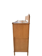 A three-tiered wooden shelving unit featuring a mix of light oak and teal-colored panels. The piece has an open, structural design with visible joinery, vertical supports that extend past the top shelf, and a horizontal backrest at the top. The middle and bottom shelves feature slatted wood center sections flanked by solid teal panels, while the top surface is primarily solid wood with teal accents at the edges.