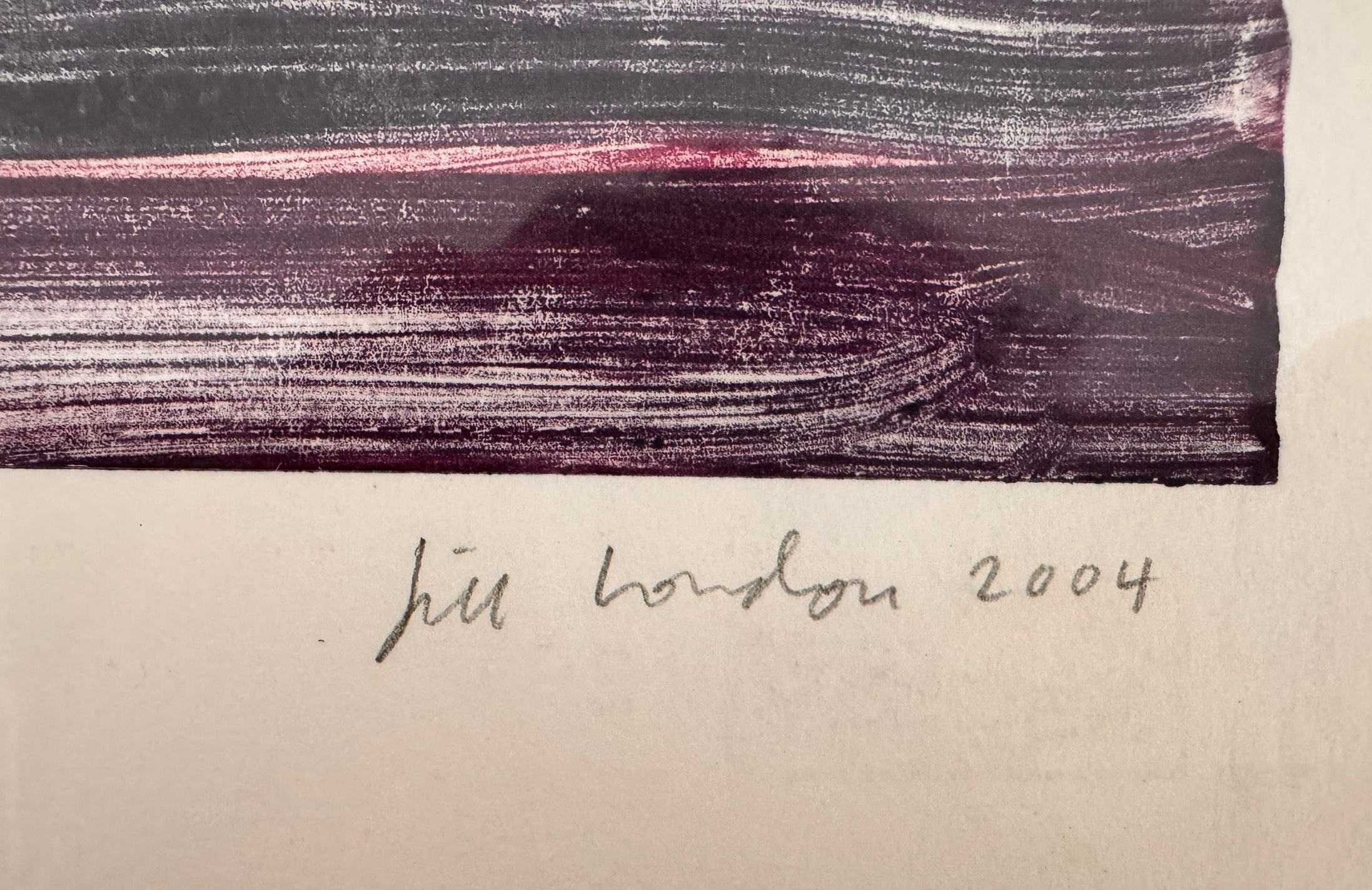 A horizontal, rectangular abstract print titled "Night Water" centered within a white mat and a thin gold frame. The artwork features dense, textured horizontal brushstrokes in deep shades of violet, indigo, and black. A prominent, gestural streak of vibrant red and a softer blush-pink band cut across the dark "water," suggesting a sunset reflection or light hitting a dark surface. The artist's signature, title, and the year 2004 are visible in pencil at the bottom.