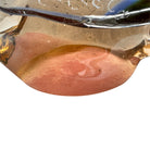 An asymmetrical Murano art glass sculpture with a heavy, biomorphic form. The piece is composed of thick, translucent smoky-amber glass with abstract, fluid bands of deep blue and dark brown swirling throughout the upper rim and sides. A dense pattern of tiny, controlled air bubbles is suspended inside the glass, concentrating heavily near the thick, solid amber base.