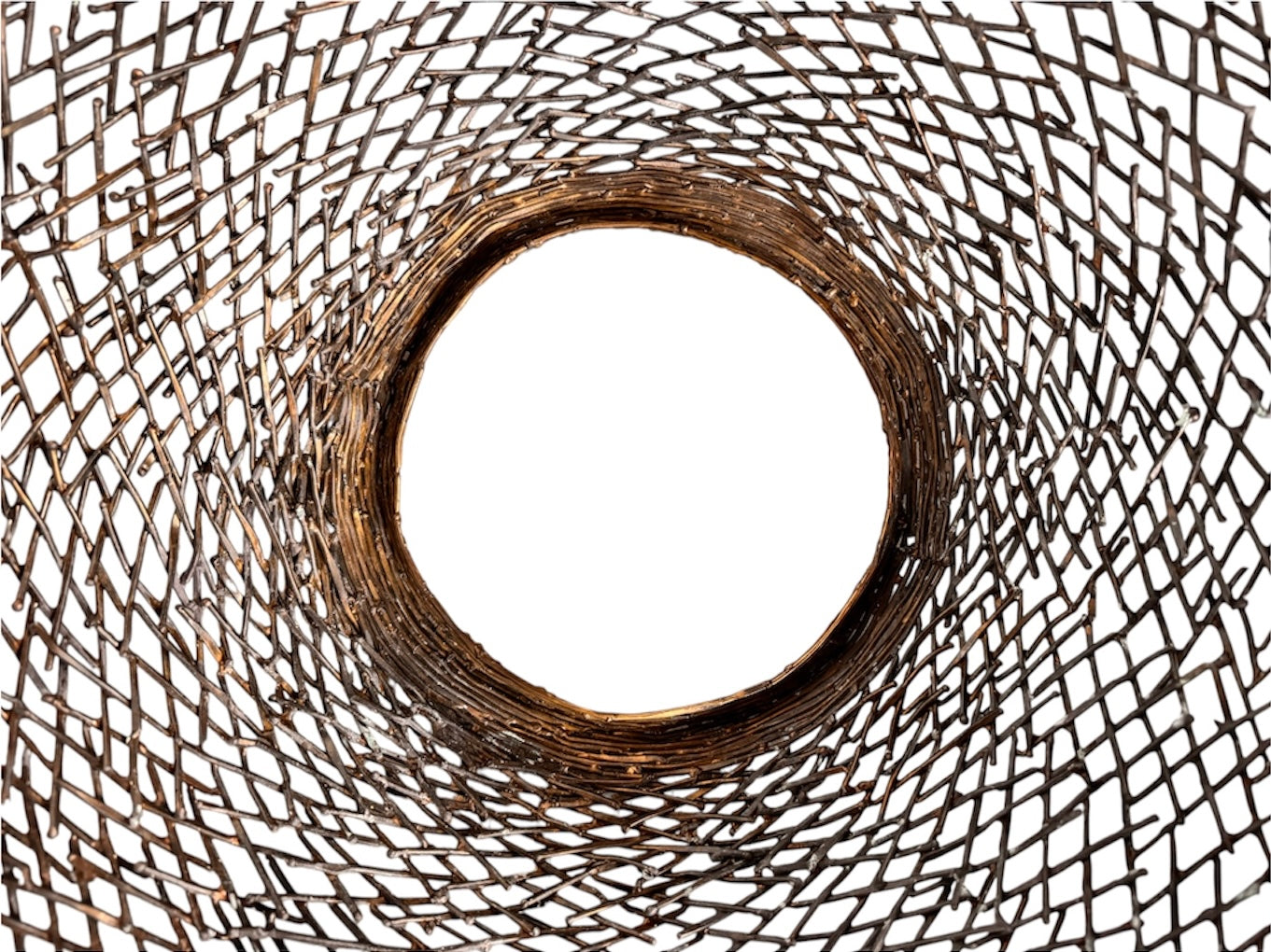 A round metal wall sculpture by Michael Aram, viewed from the front against a stark white background. The piece is composed of a dense, intricate lattice of fine, dark metal wire or twigs woven together to create a textured, web-like pattern. The structure curves inward like a funnel or a vortex, sloping down toward a clean, circular opening in the exact center, creating a strong sense of depth and dimensionality.