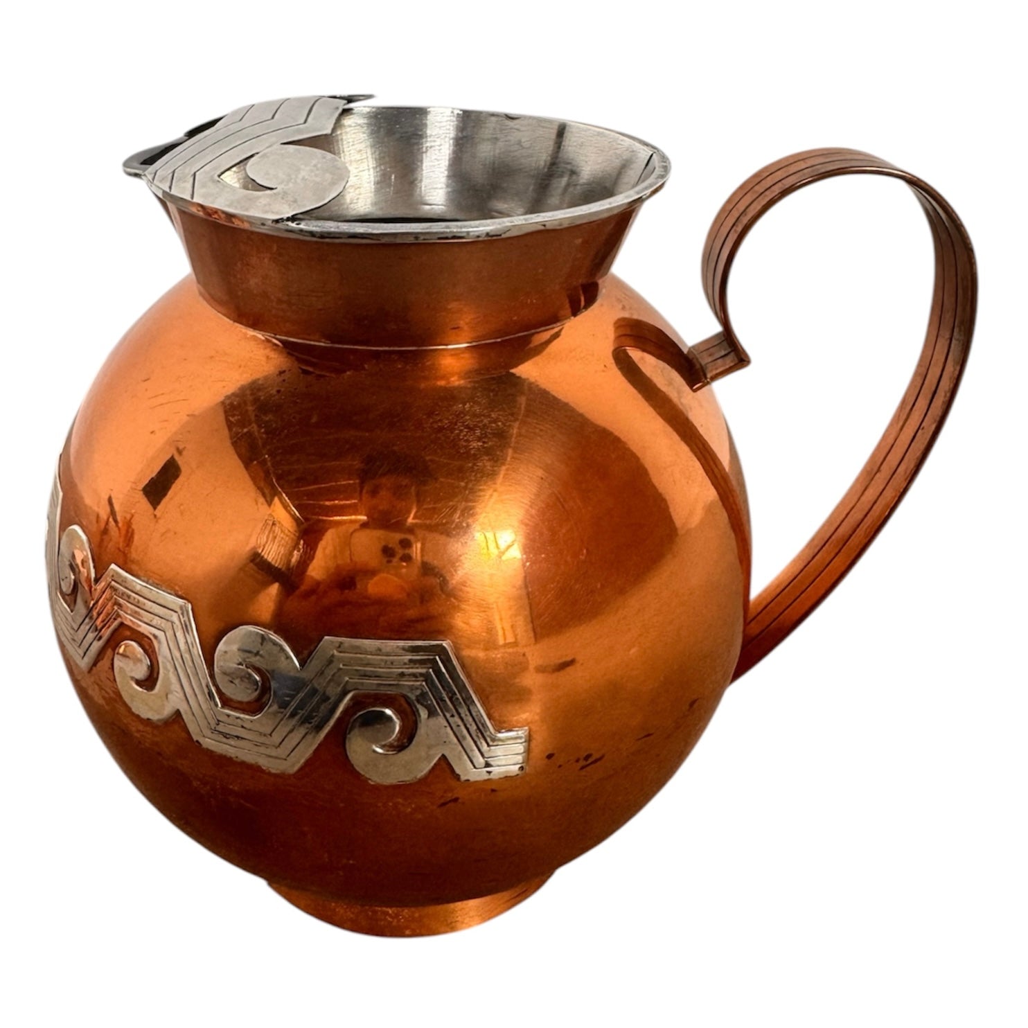 The set includes a large, rectangular, hammered copper tray with geometric openwork handles. Resting on the tray is a tall, slightly tapered copper coffee pot with a wooden handle, a matching smaller creamer pitcher with a similar wooden handle, a lidded sugar bowl, and a tiny matching metal cup or jigger. To the right off the tray sits a large, spherical copper water pitcher or jug with a wide mouth and ice lip.