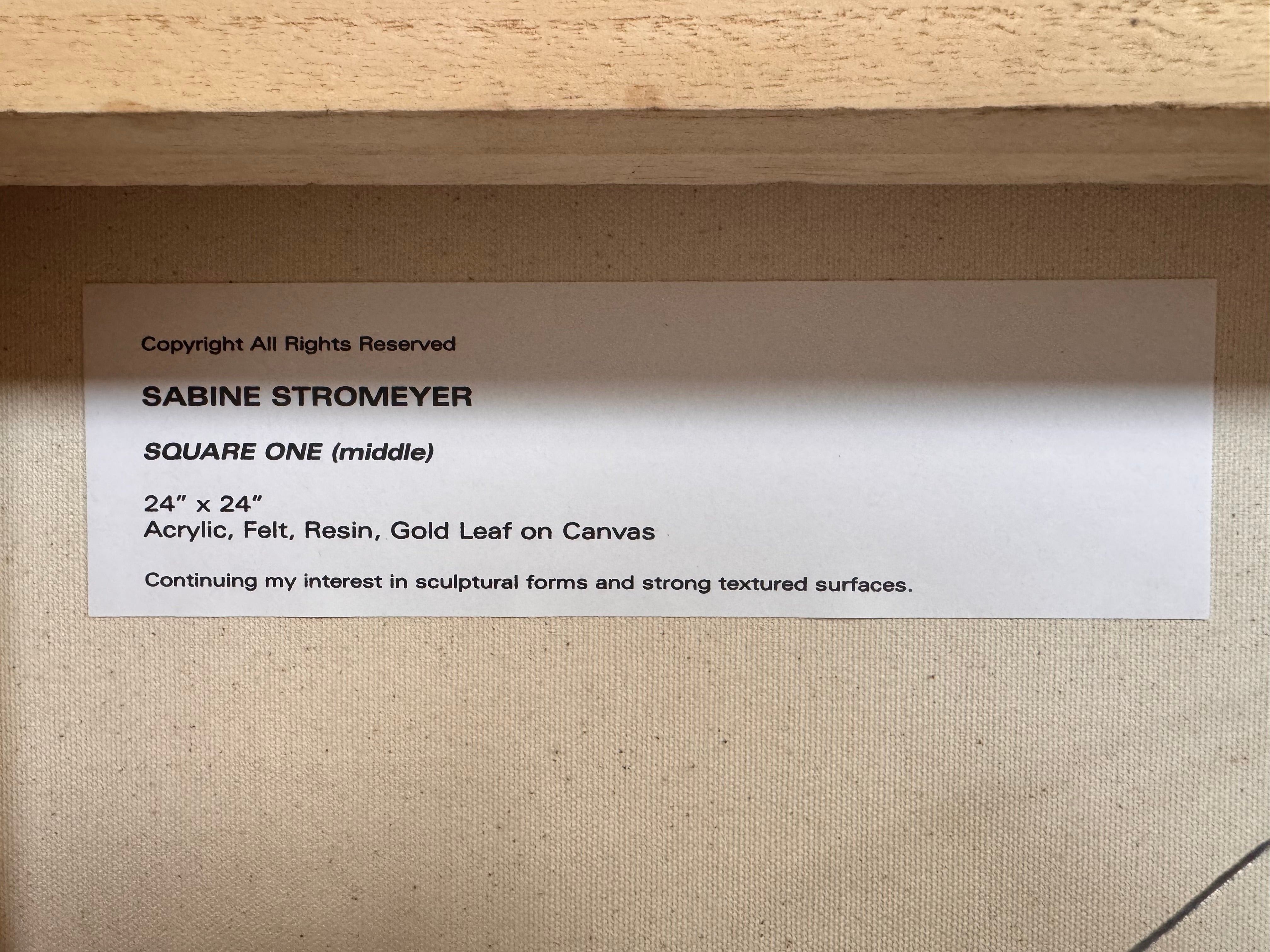 A triptych of abstract paintings featuring a grid pattern of textured black squares by Sabine Stromeyer called “Square One”. The left and right panels each have a single vertical gold rectangle in the center, while the middle panel has two stacked gold rectangles in the center.