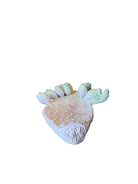 A white and green, glazed ceramic platter in the shape of a prickly pear cactus pad with attached prickly pear fruit. The surface has raised dots representing spines. 