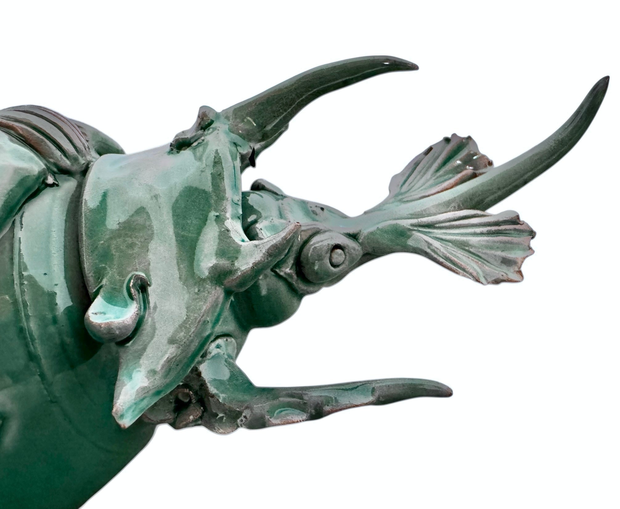A ceramic sculpture of a stylized beetle by Enza Fasano, featuring a deep emerald green glaze with dark, metallic bronze-colored accents. The beetle is depicted with a highly textured, ribbed shell (elytra) and prominent, curved horns. Its legs are stylized with suckers, reminiscent of octopus tentacles. The piece has a glossy finish and rests against a plain white background.