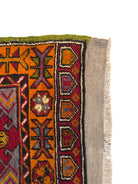 Anatolian Yastik rug with red, gold, green and gray geometric patterns and fringe.
