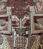 A pair of antique, heavily carved Anglo-Indian style throne chairs featuring lion figures as legs and arm supports, and peacock motifs on the backrests. The chairs have a distressed, multi-colored painted finish.