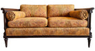 An elegant, two-seater Neoclassical-style settee featuring a dark wood frame and golden-orange botanical upholstery. The settee has a straight back with two rectangular cushions and two matching bolster pillows tucked against the scrolled, dark wood arms. The fabric is a rich tapestry weave with a large-scale, stylized leaf pattern in autumnal shades of gold, amber, and terracotta. The wooden frame is detailed with fluted stiles and tapered, turned legs.