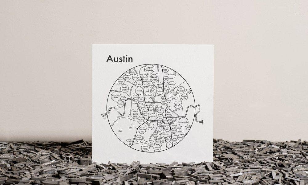 Map of Austin on a white background with a textured surface below
