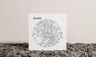 Map of Austin on a white background with a textured surface below
