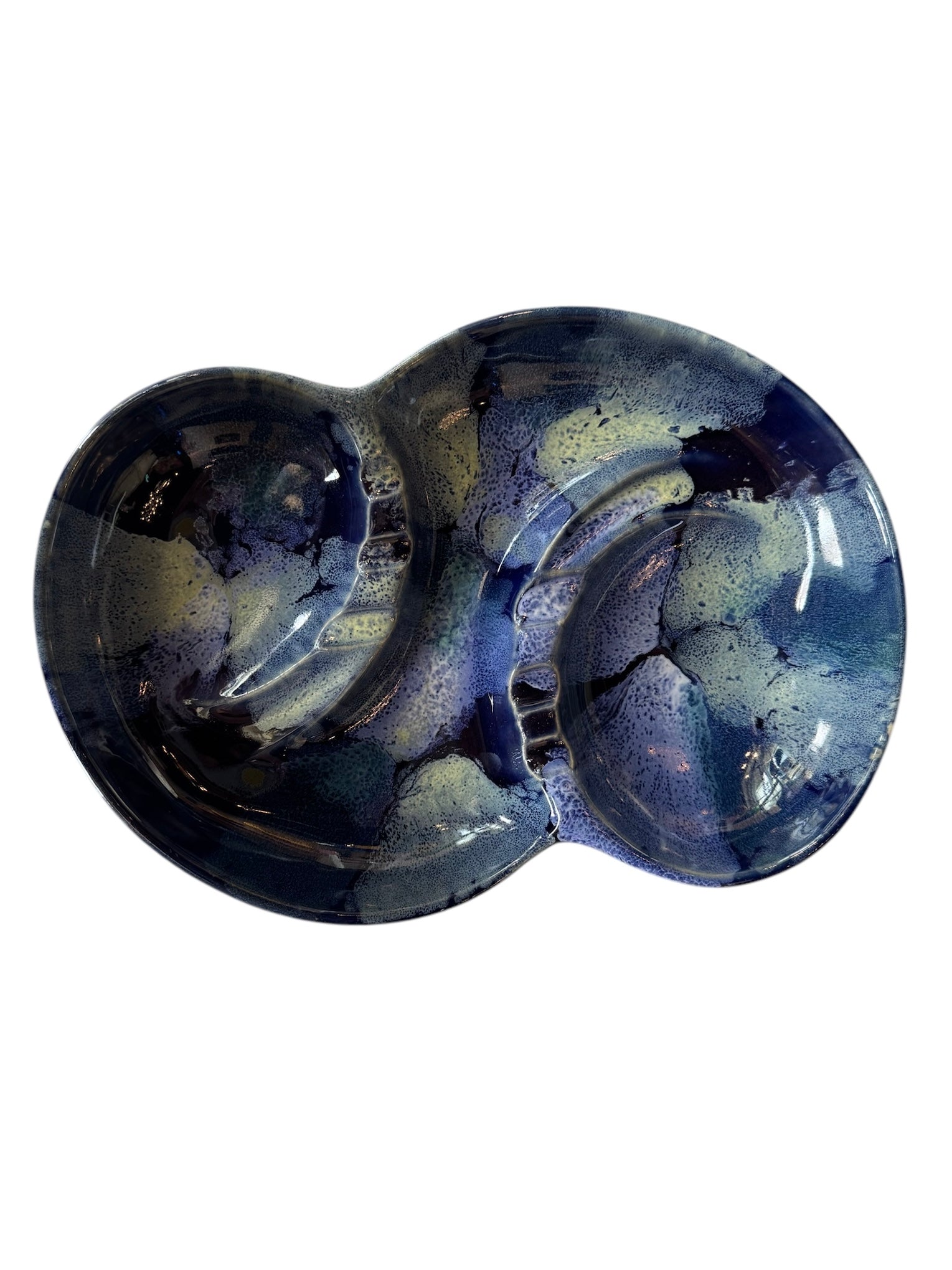 Vintage McCoy ashtray. Glazed in dark blue and marbled with lighter blues. The bottom is stamped 'McCoy USA.'"