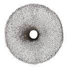 A round metal wall sculpture by Michael Aram, viewed from the front against a stark white background. The piece is composed of a dense, intricate lattice of fine, dark metal wire or twigs woven together to create a textured, web-like pattern. The structure curves inward like a funnel or a vortex, sloping down toward a clean, circular opening in the exact center, creating a strong sense of depth and dimensionality.