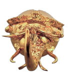 A handcrafted ceramic sculpture of a rhinoceros beetle by Enza Fasano, featuring a brilliant, high-gloss gold metallic finish. The beetle is captured in a dynamic, slightly upturned pose with detailed textures on its ribbed shell and prominent, curved horns. The piece reflects light across its polished surface, showcasing the artist’s signature fusion of traditional Pugliese pottery and contemporary luxury.