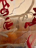 A vertical abstract work on a weathered gold-leaf panel. The upper section features bold, dark red calligraphic symbols resembling distorted kanji or script. Below, delicate, dotted white lines wind through the composition like strings of pearls or constellations. A slender, vertical form in vibrant red stands on the right, while muted, smoky-grey washes of paint ground the bottom of the piece.