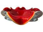 A Murano art glass bowl featuring a vibrant red interior encased in white glass, with a decorative ruffled edge. The piece is handblown, showcasing the Incamiciato technique.