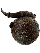 Glossy dark brown ceramic bull sculpture with intricate, hand-incised swirling patterns and a nose ring.