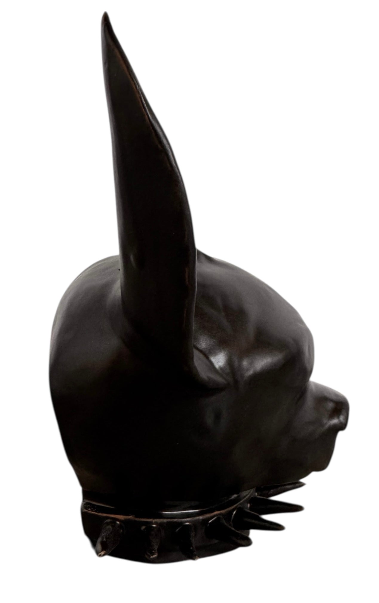 A smooth, dark black-colored ceramic sculpture of a Miniature Pinscher's head. The stylized dog features large, upright pointed ears and a prominent spiked collar around its neck. The surface has a soft sheen, with minimalist indentations for eyes and a rounded snout, creating a sleek and modern aesthetic.