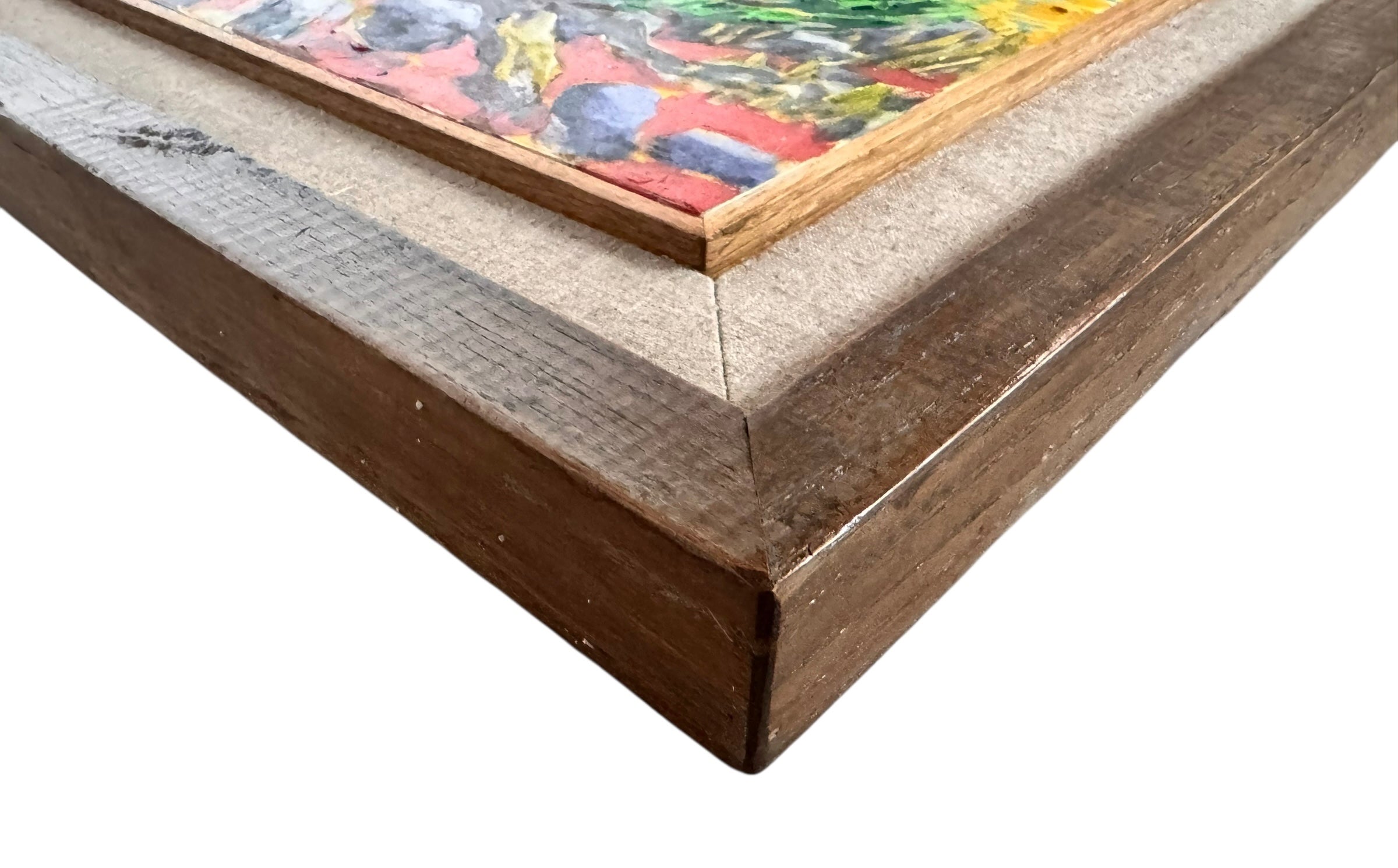 A vibrantly colored landscape painting titled 'Perdernales Falls Fisherman,' featuring two large trees with prominent exposed roots framing a body of water. A lone figure, a fisherman, stands by the water in the middle ground. The painting uses bold strokes of yellow, green, red, and blue, and is enclosed in a rustic dark wooden frame with a light-colored inner mat.