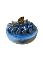 Close-up of Domenico Pinto's 'Mare Dentro' ceramic sculpture: foot, ship with gold sail, Apulian style