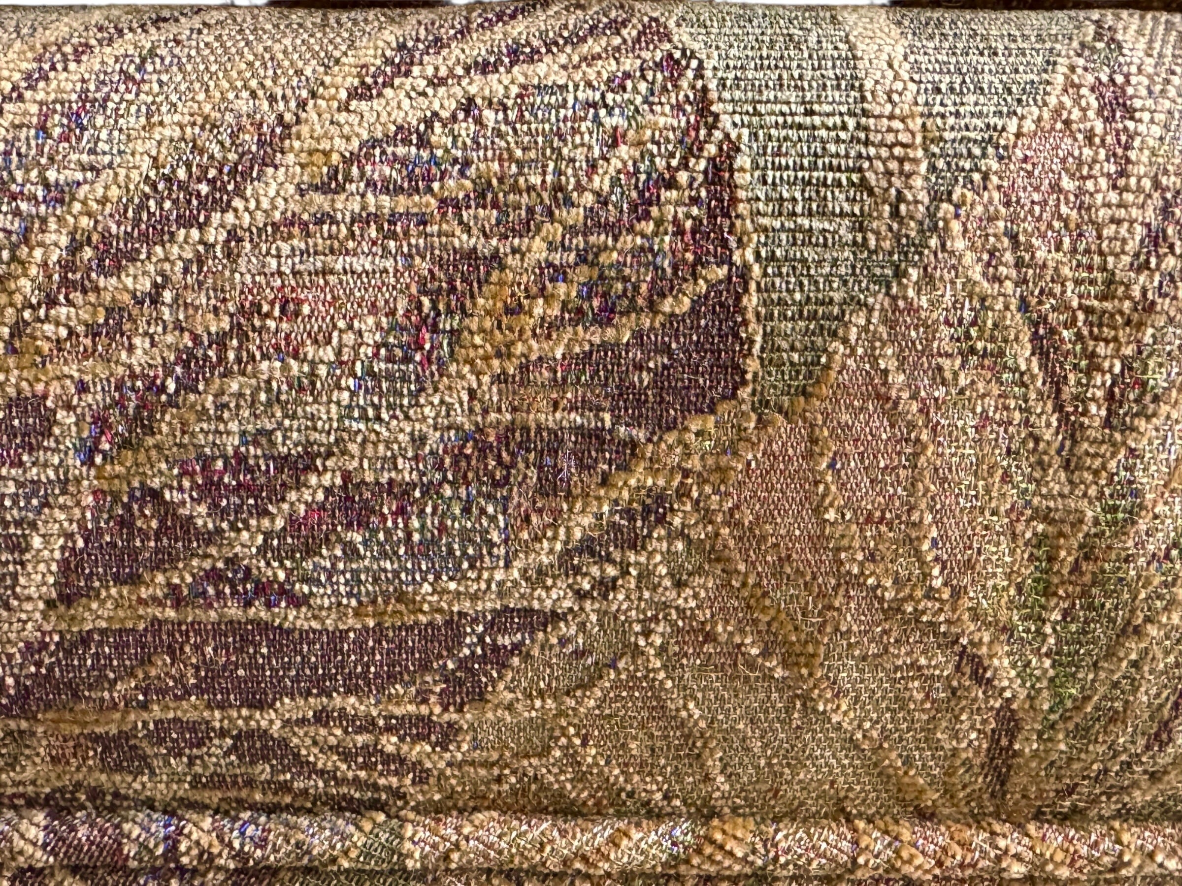 A Neoclassical-style wooden loveseat with a dark mahogany frame featuring scrolled arms and tapered legs. The upholstery consists of plush cushions and two matching cylindrical bolster pillows, all covered in a golden-yellow jacquard fabric with a large-scale, repeating autumnal leaf pattern in shades of muted orange and brown.