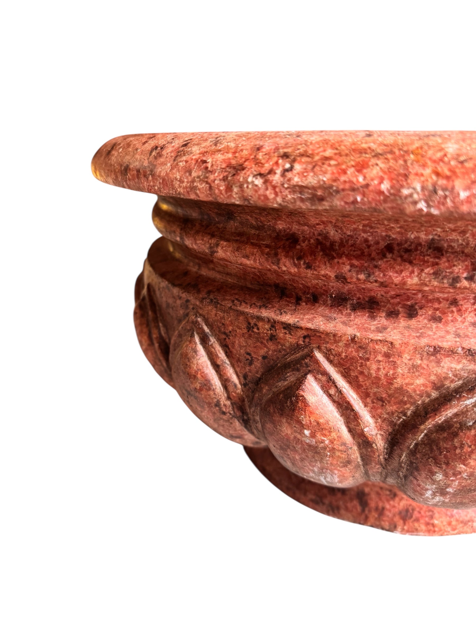 A carved pink granite planter with a leaf pattern, designed for indoor use without drainage.