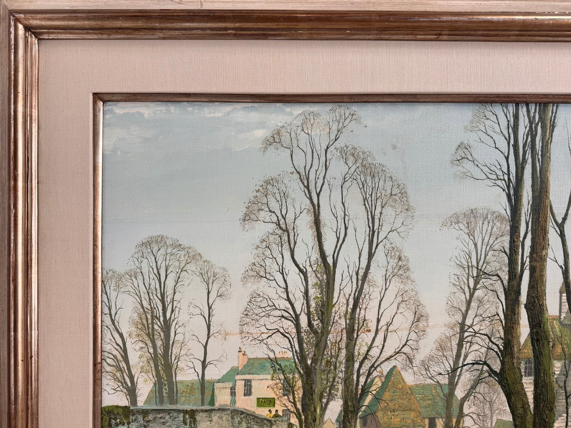 A naturalistic landscape oil painting by Michael Reilly titled "Mill Pond with Bridge" depicts a small town scene with a stone bridge over a mill pond, several buildings, and numerous bare trees under a grey sky