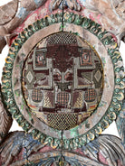 A pair of antique, heavily carved Anglo-Indian style throne chairs featuring lion figures as legs and arm supports, and peacock motifs on the backrests. The chairs have a distressed, multi-colored painted finish.