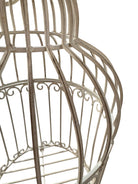 A single, white or cream-colored, decorative wrought iron bird cage with a hinged door and a hanging loop at the top. The cage has a vintage or antique style 