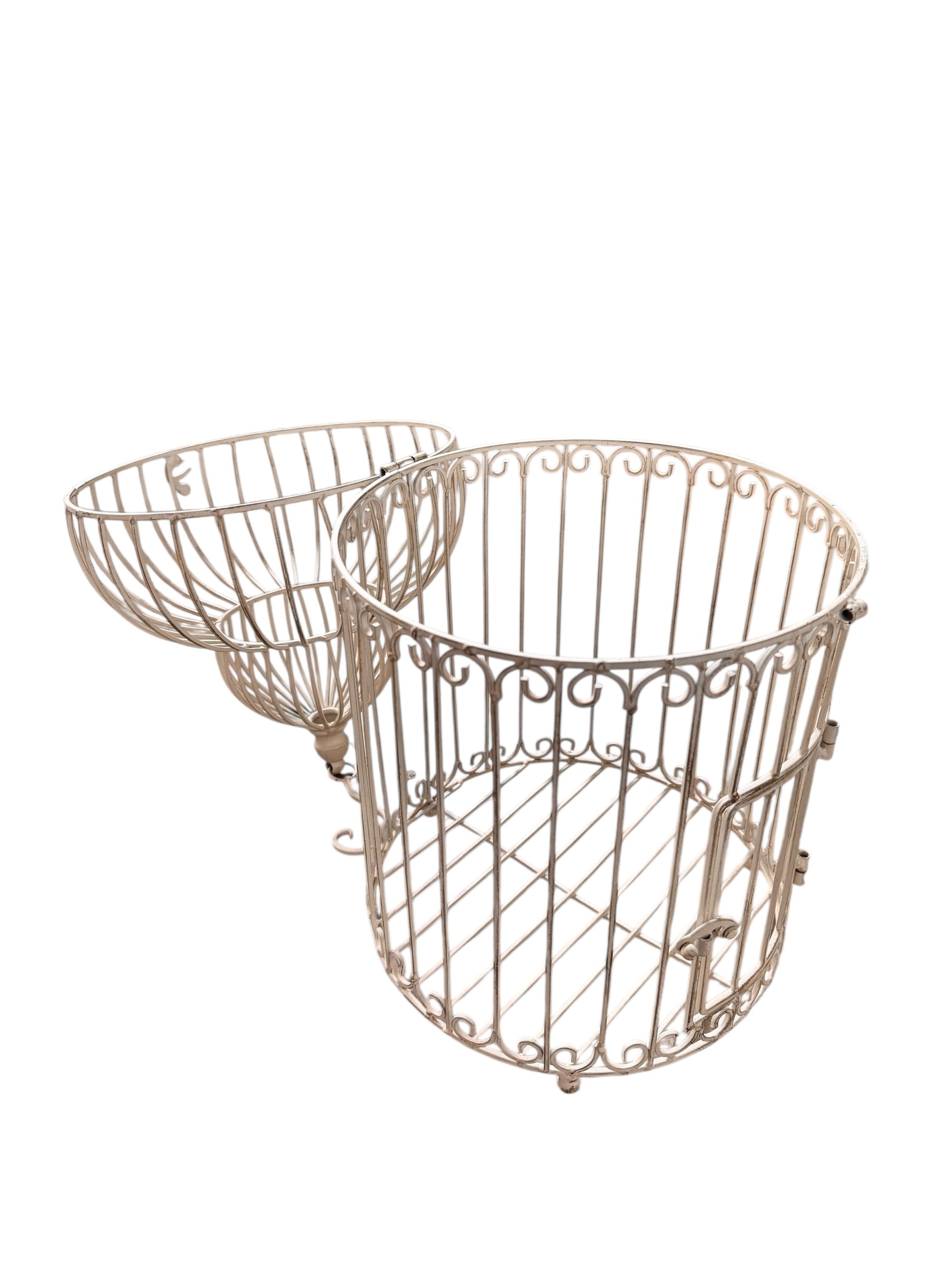 A single, white or cream-colored, decorative wrought iron bird cage with a hinged door and a hanging loop at the top. The cage has a vintage or antique style 