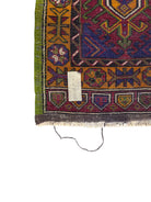 Anatolian Yastik rug with red, gold, green and gray geometric patterns and fringe.
