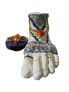 Ceramic foot sculpture by Domenico Pinto featuring hand-painted details, gold accents, a sacred heart, and an angel figure with a blindfold