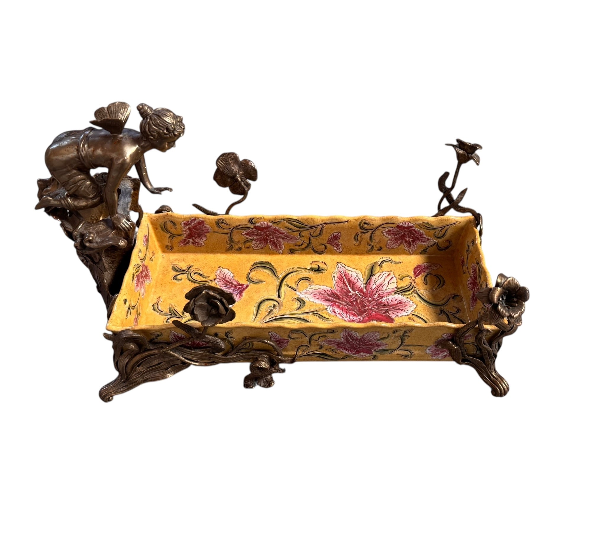 A rectangular yellow porcelain jardiniere with hand-painted red flowers and green foliage, mounted in ornate gilt bronze. The bronze features scrolled feet, delicate floral stems, and a winged fairy nymph figure perched on one side.

