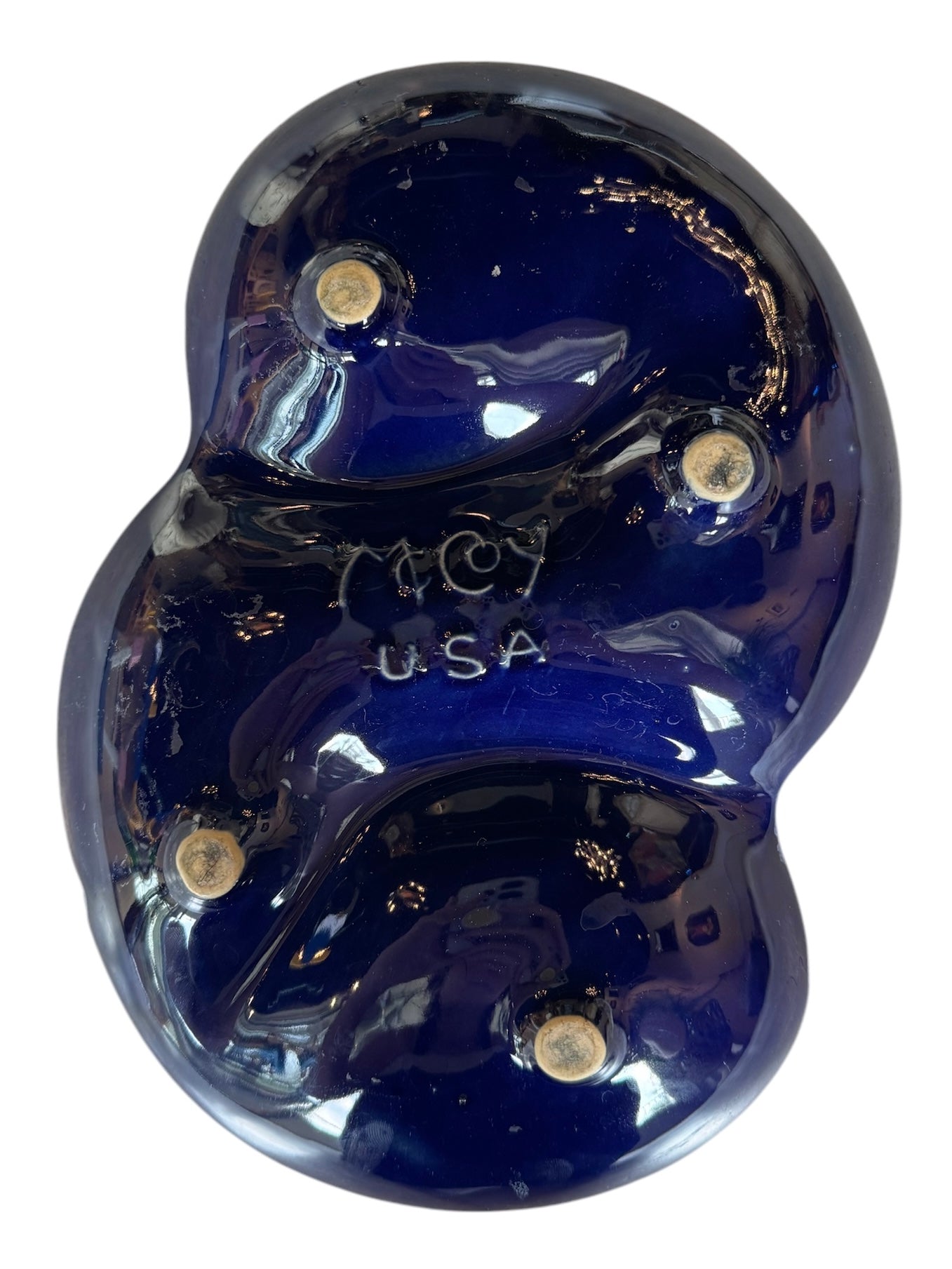 Vintage McCoy ashtray. Glazed in dark blue and marbled with lighter blues. The bottom is stamped 'McCoy USA.'"