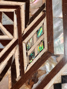An ornate octagonal Syrian inlaid box, intricately decorated with geometric patterns made from dark wood, iridescent mother-of-pearl, vibrant abalone shell, and pale bone