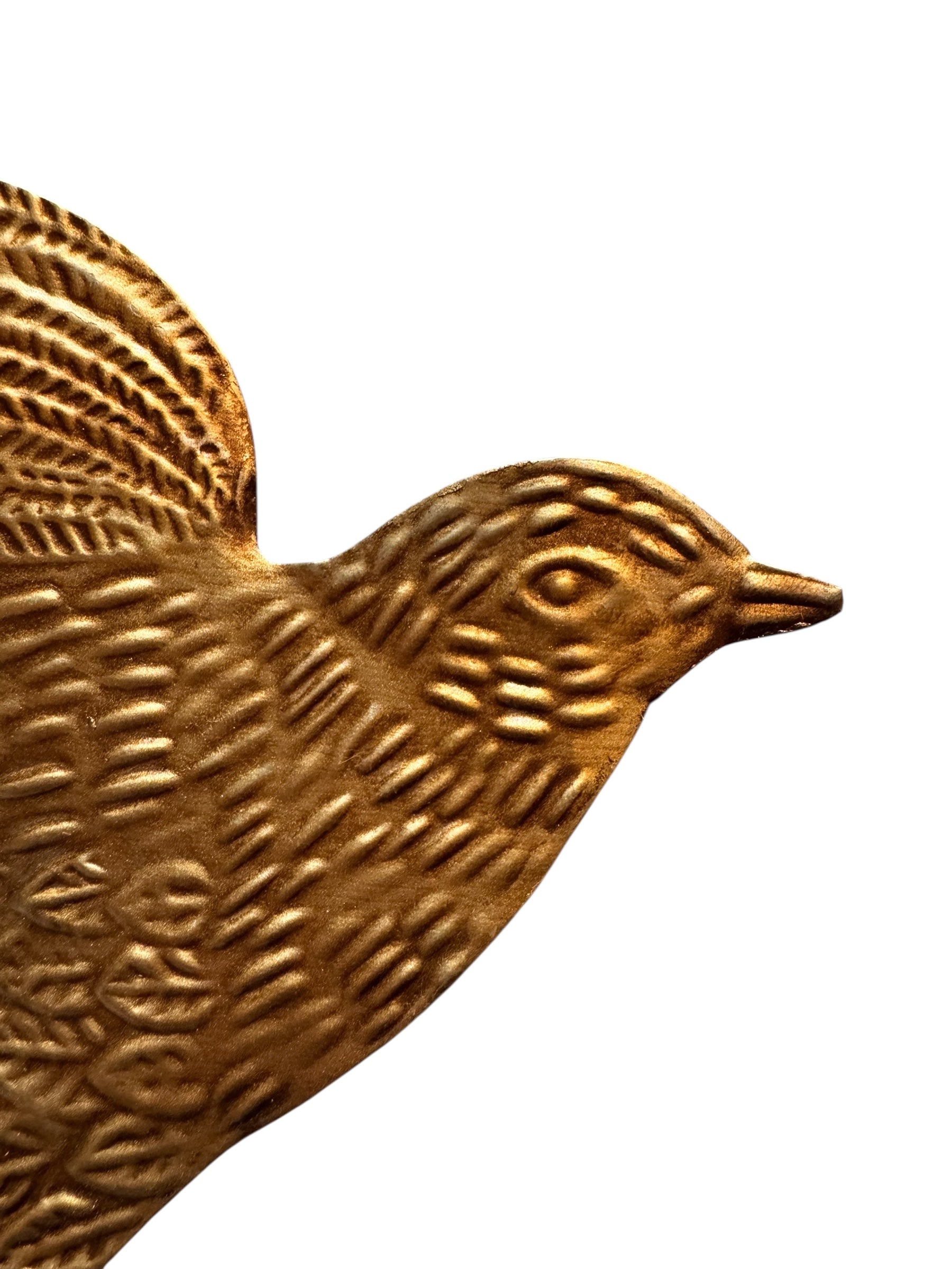 mage of a vintage-style, gilded tin bird with embossed feather detailing. A green velvet ribbon is attached. Front and back views shown.