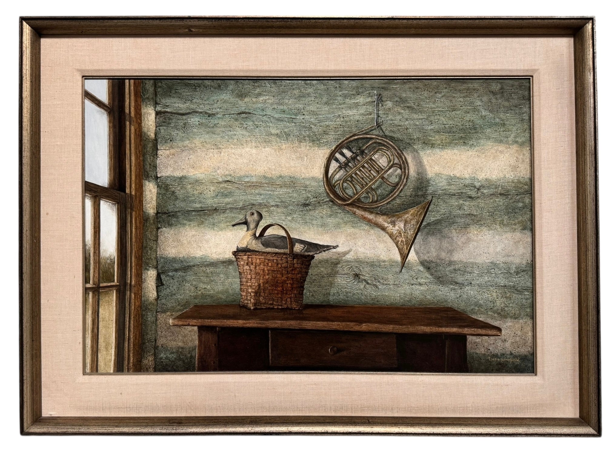A realistic painting of a rustic interior scene by Travis Whitfield. A duck sits inside a woven basket on a dark wooden table with a single drawer. A French horn hangs on the light blue and white log wall behind the table. A multi-pane window on the left side of the painting shows an outdoor view. 