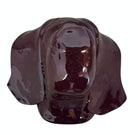 A glossy, dark chocolate brown ceramic bust of a Labrador dog. Created by Enza Fasano, the sculpture features a minimalist, stylized design with smooth, flowing lines and a high-shine glaze that reflects light. The dog’s long ears drape down the sides, and its snout is rounded, capturing the gentle essence of the breed in a contemporary Italian pottery style.