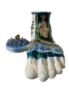 Close-up of Domenico Pinto's 'Mare Dentro' ceramic sculpture: foot, ship with gold sail, Apulian style