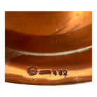 The set includes a large, rectangular, hammered copper tray with geometric openwork handles. Resting on the tray is a tall, slightly tapered copper coffee pot with a wooden handle, a matching smaller creamer pitcher with a similar wooden handle, a lidded sugar bowl, and a tiny matching metal cup or jigger. To the right off the tray sits a large, spherical copper water pitcher or jug with a wide mouth and ice lip.