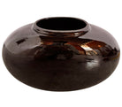 A round, glossy black vase with a small opening.
The vase has a spherical or gourd-like shape and a highly reflective, black glazed finish.