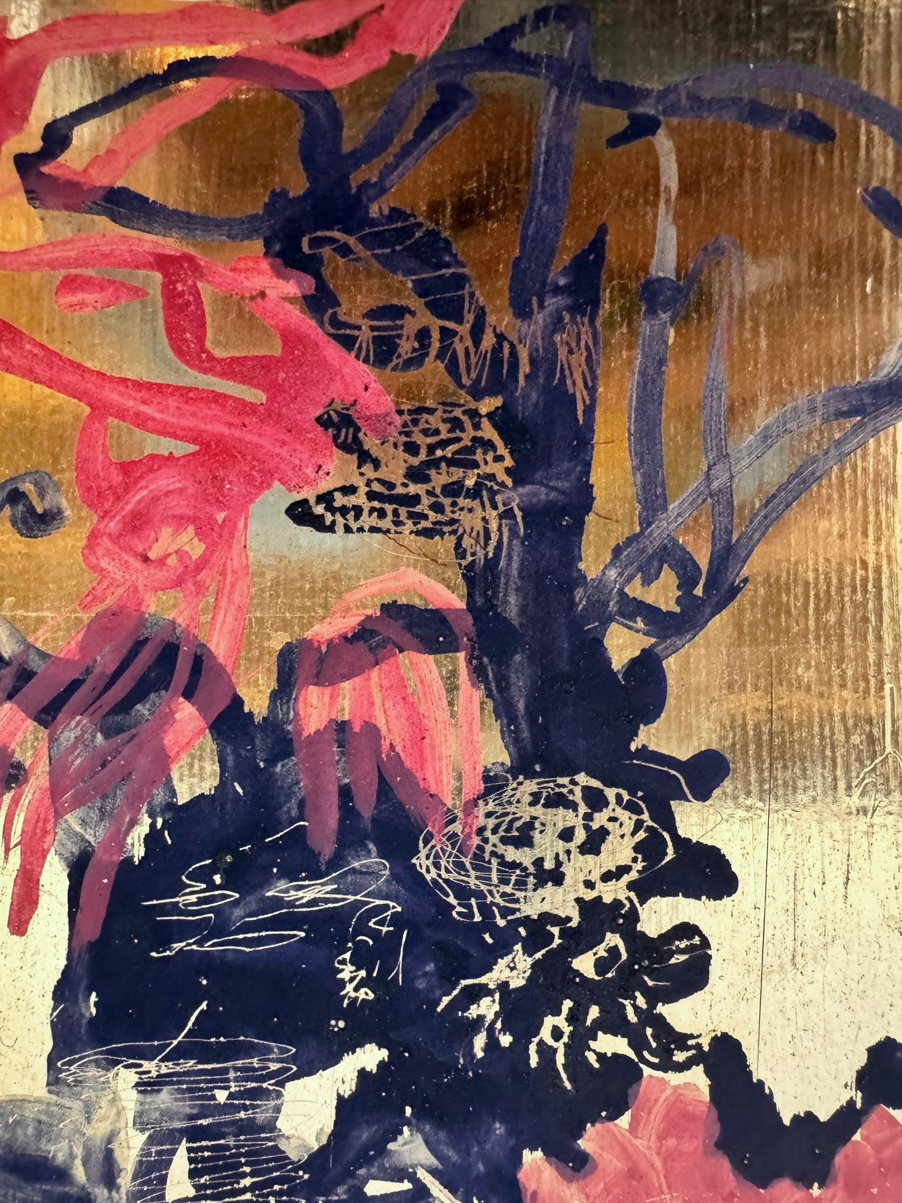 A vibrant abstract painting on a metallic gold-toned panel characterized by dense, energetic layering. The palette is dominated by saturated pinks, deep blacks, and earthy oranges.
In the upper half, horizontal strokes of orange and pink suggest a sunset or landscape, while the lower half features heavy, gestural applications of black paint that anchor the composition. Fine, white or silver linear scribbles are scratched into or layered over the pigment, adding a sense of frantic movement.