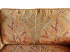 A Neoclassical-style wooden loveseat with a dark mahogany frame featuring scrolled arms and tapered legs. The upholstery consists of plush cushions and two matching cylindrical bolster pillows, all covered in a golden-yellow jacquard fabric with a large-scale, repeating autumnal leaf pattern in shades of muted orange and brown.