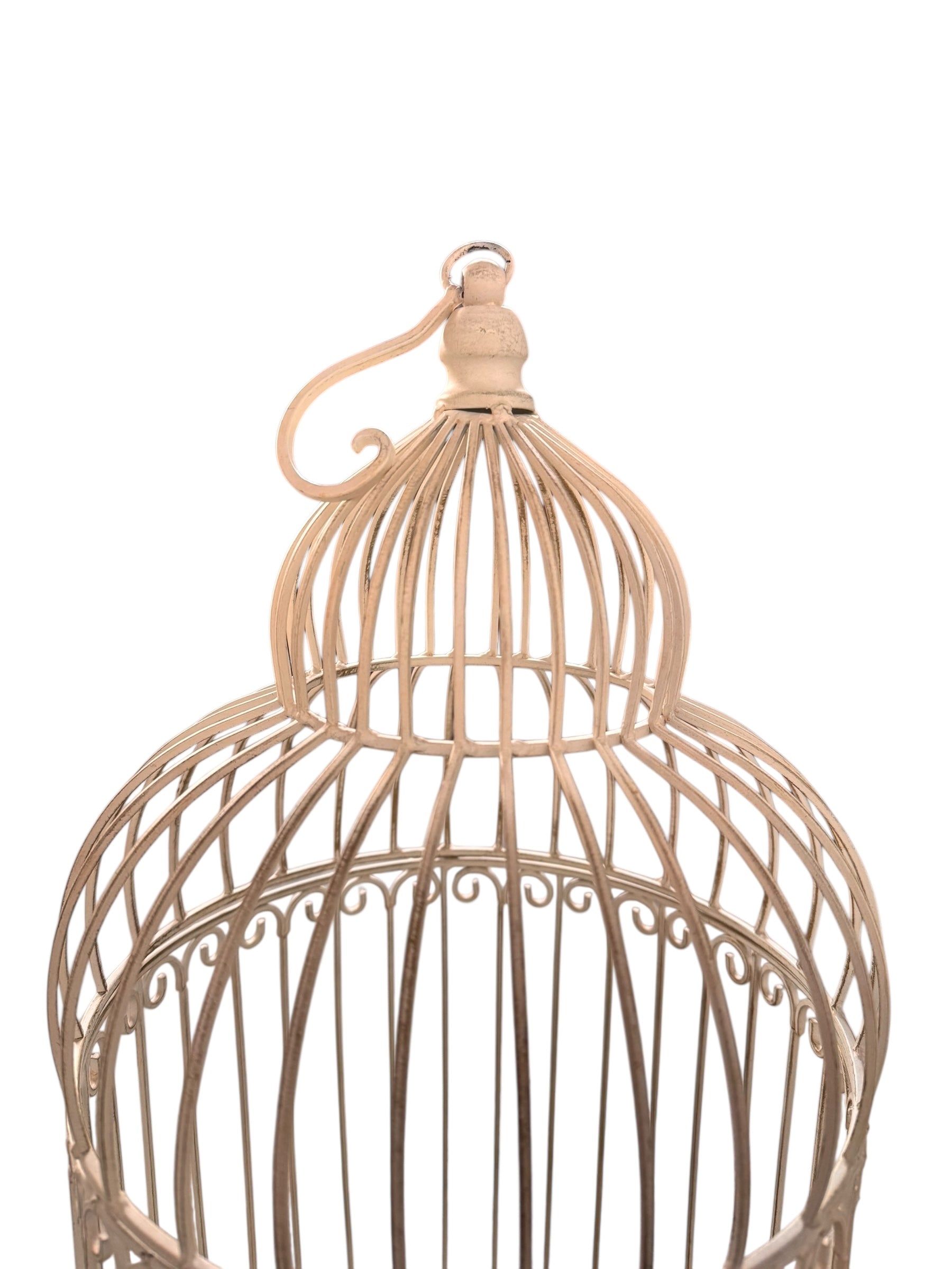 A single, white or cream-colored, decorative wrought iron bird cage with a hinged door and a hanging loop at the top. The cage has a vintage or antique style 