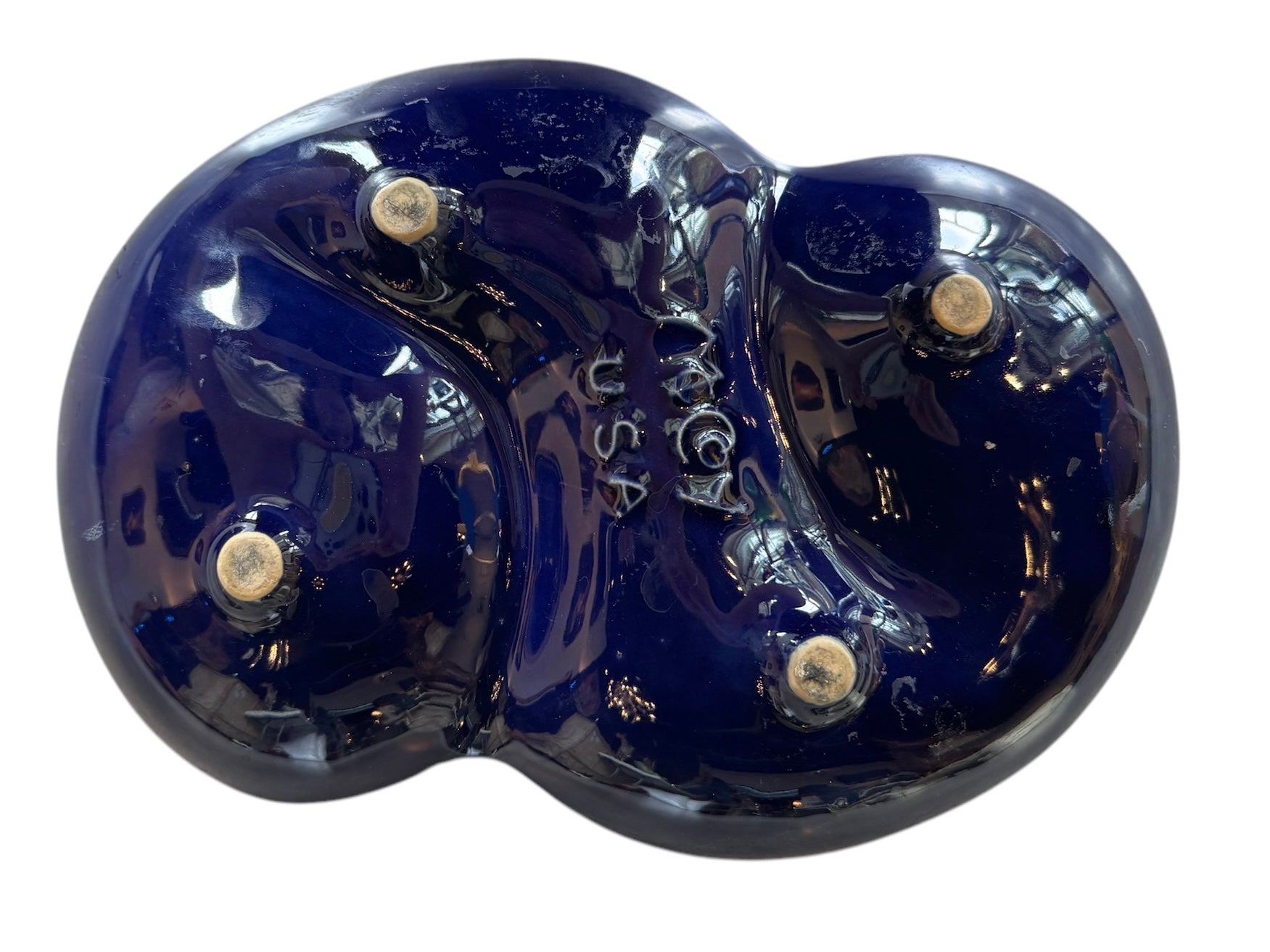 Vintage McCoy ashtray. Glazed in dark blue and marbled with lighter blues. The bottom is stamped 'McCoy USA.'"